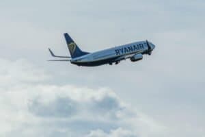 A Ryanair plane soaring through the sky above Wrocław, Poland.