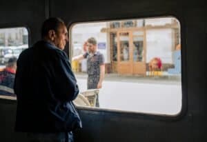 Adult man looking out a ferry window in İstanbul, capturing the city's bustling ambiance.