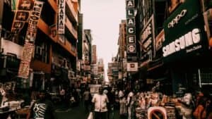 Bustling street market in Colombo, Sri Lanka with diverse people and vibrant signs.