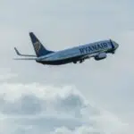 A Ryanair plane soaring through the sky above Wrocław, Poland.