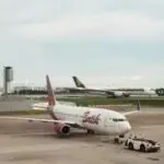 Two airplanes at an airport, showcasing commercial aviation on the tarmac.