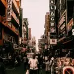 Bustling street market in Colombo, Sri Lanka with diverse people and vibrant signs.